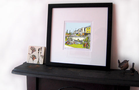 print of Blackpool FC, Bloomfield Road displayed on a mantlepiece