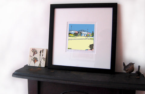 DW Stadium Print displayed on a mantlepiece
